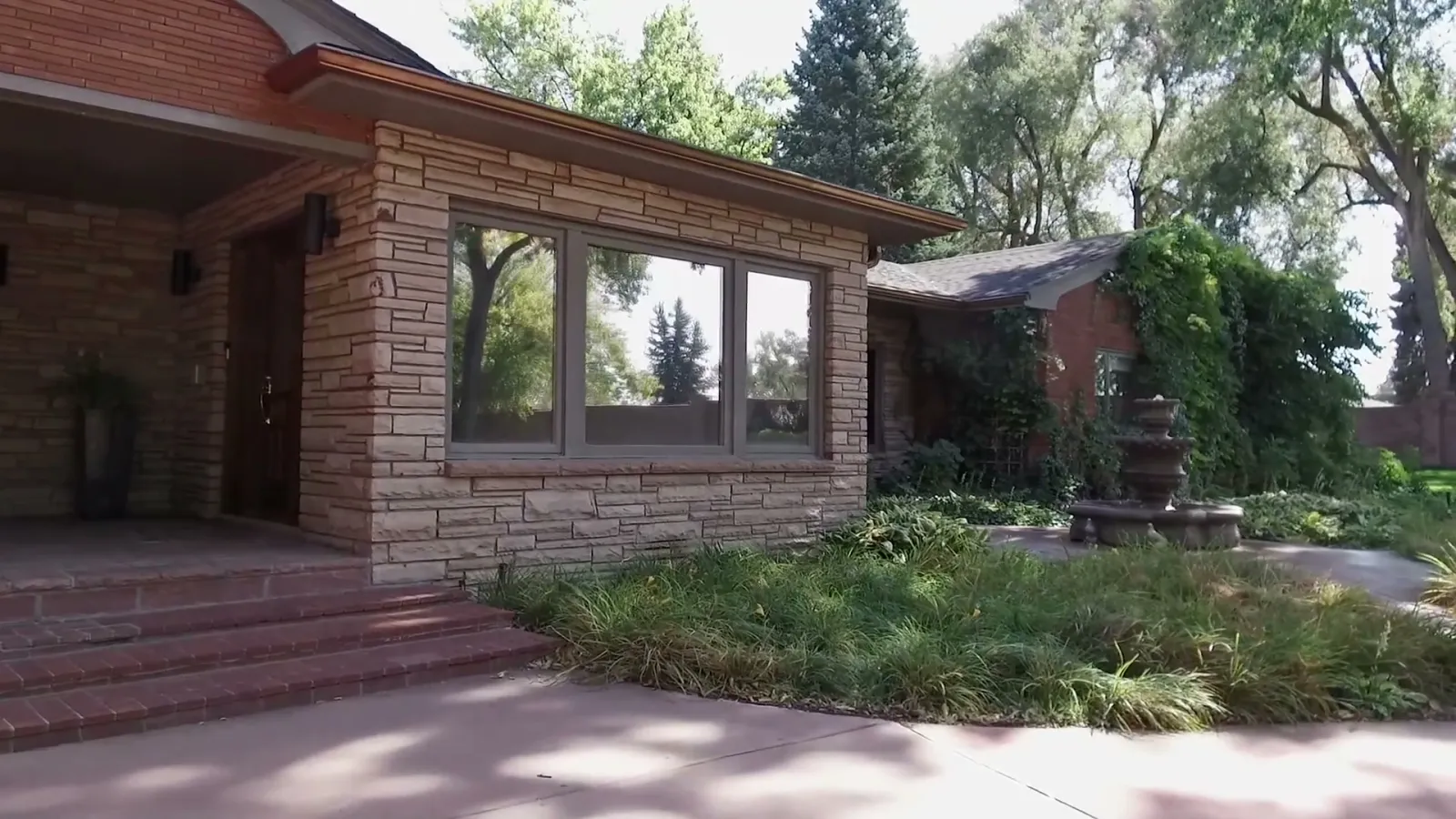 Stone, brick, deep eaves, and the compressed entrance court.