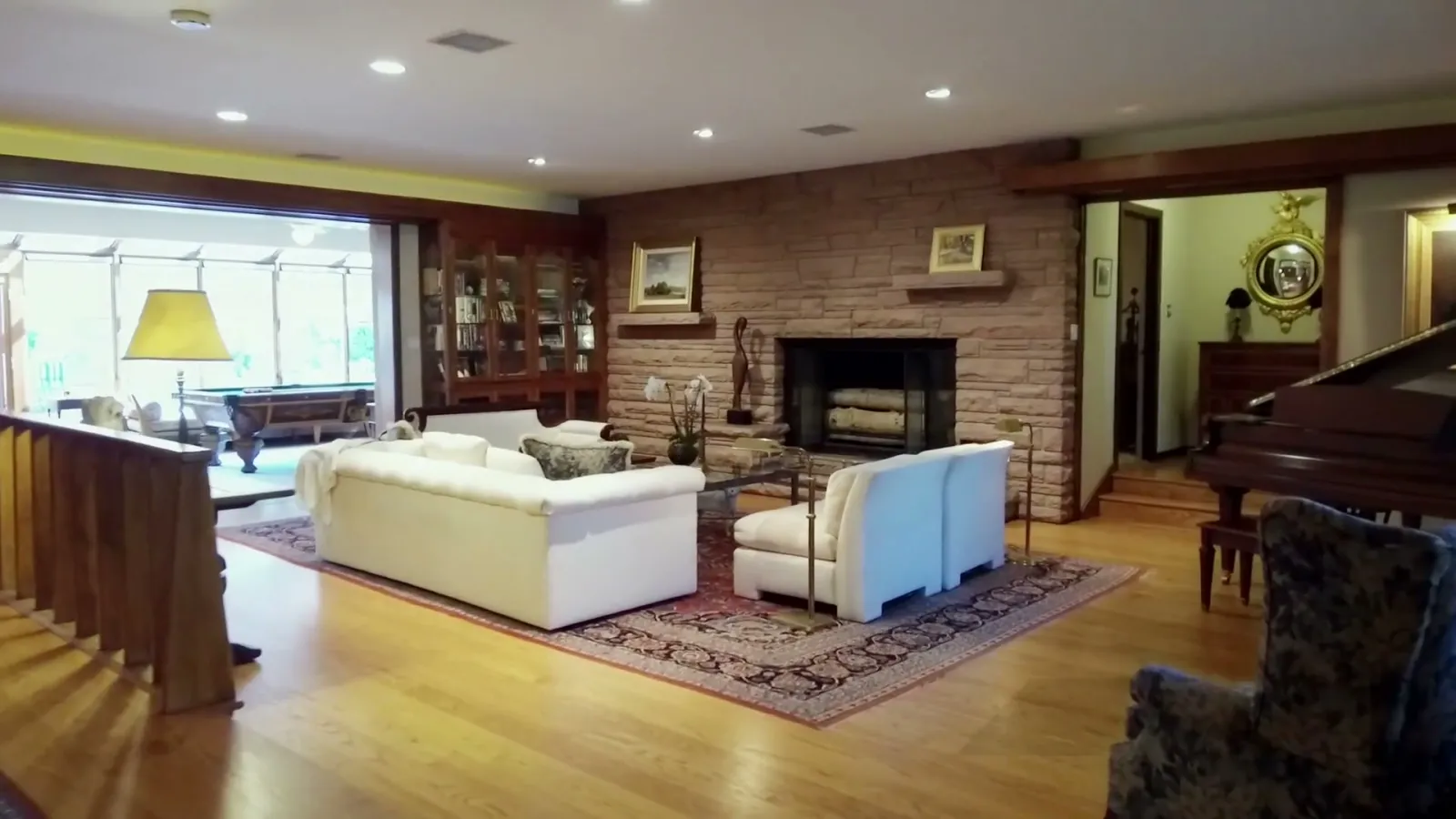The main living room, with masonry fireplace and broad garden light.