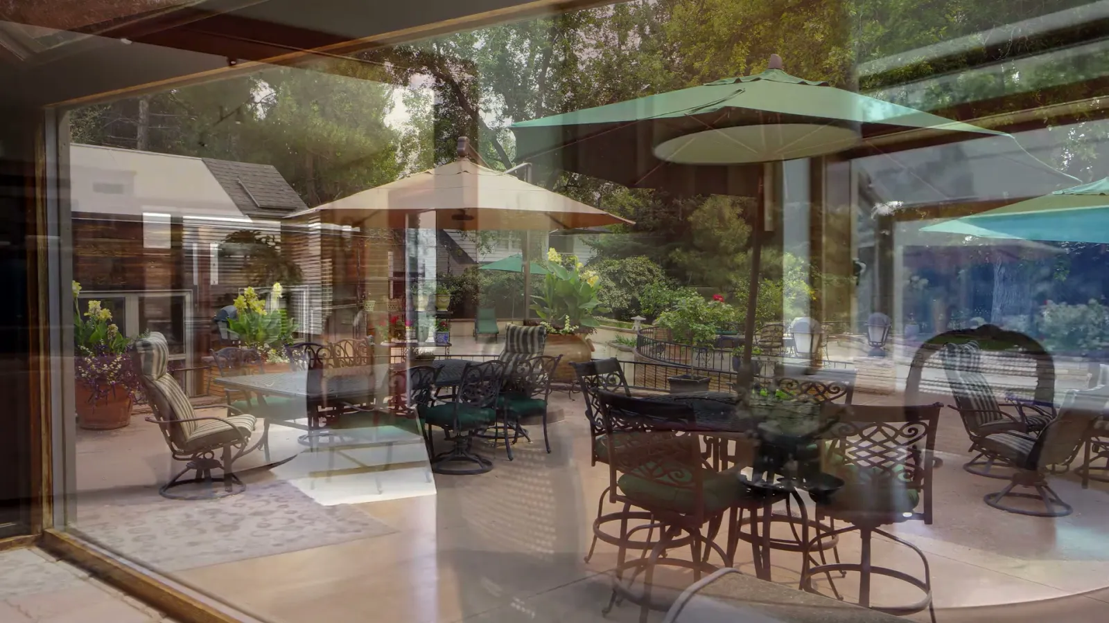 A patio room seen through glass: inside and outside repeatedly overlap.