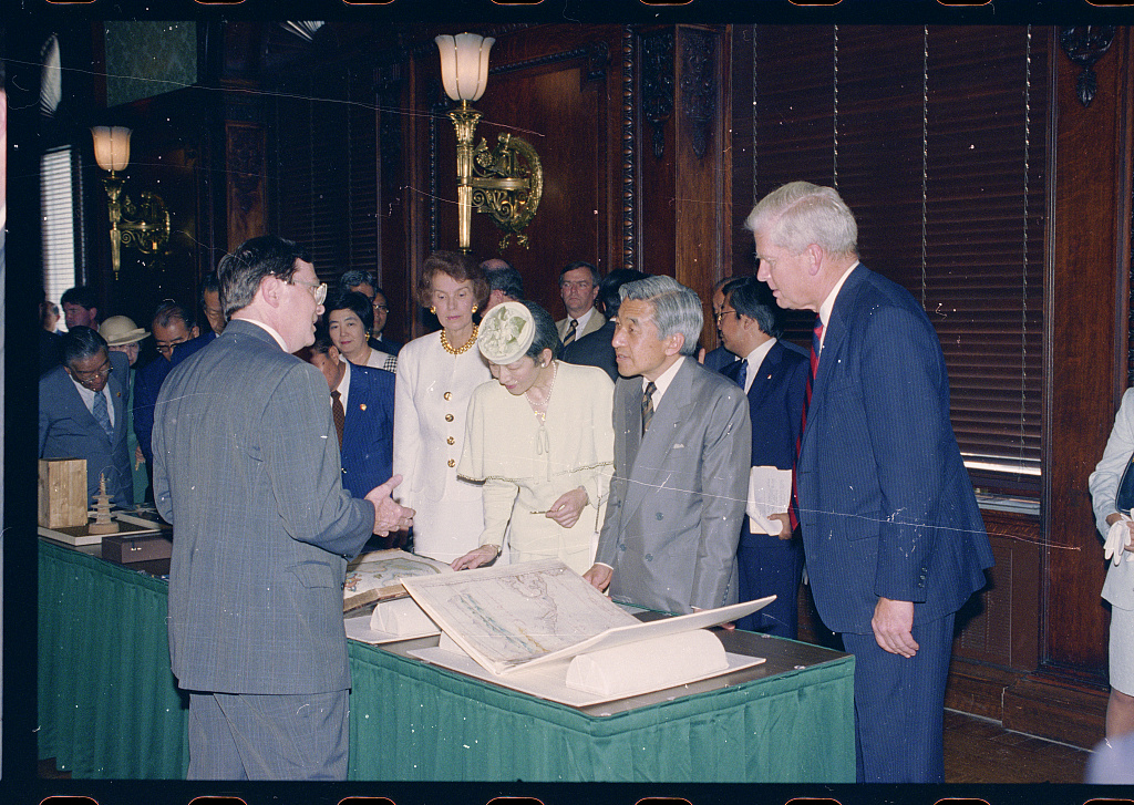 The imperial couple viewing collection materials at the Library of Congress